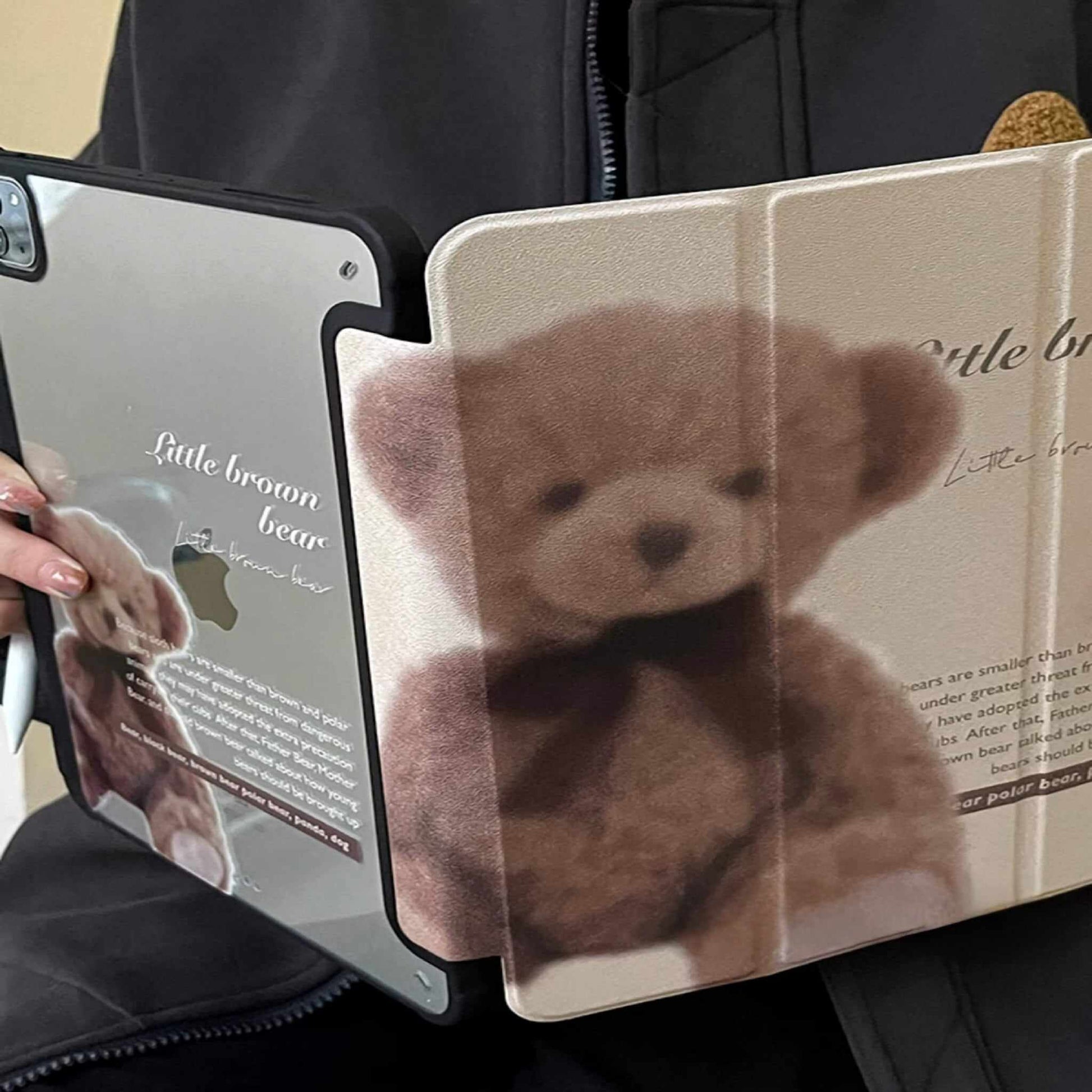"Beige iPad case with a vintage teddy bear design and scripted text, displayed next to a white ceramic mug. Acrylic clear back with a slot for Apple Pencil."