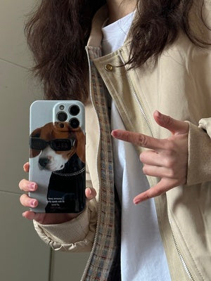 iPhone case. Original design iPhone cases with dog illustrations. Half-covered, super slim & lightweight phone case. Hard polycarbonate material. Women holding front view.