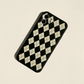 iPhone case with black colour based featuring white retro Checkerboard illustrations. Made from soft TPU polystyrene plastic material. Back rotated view