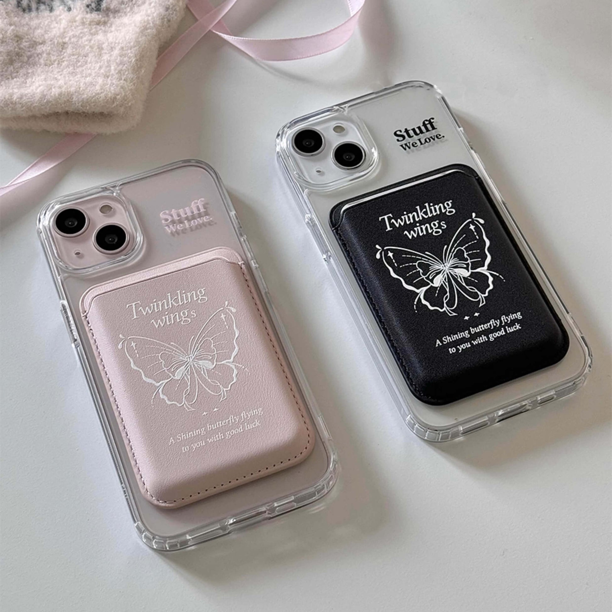 Two MagSafe-compatible phone cases, one pink and one black, each with an embossed butterfly and 'Twinkling wings' text, symbolizing good luck, set against a clear case background