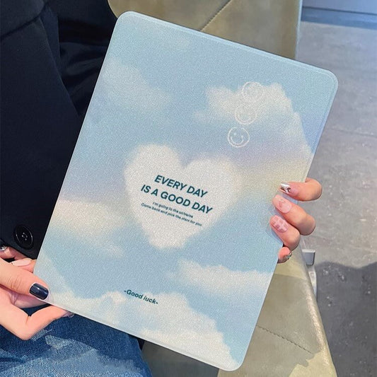 Held against a modern backdrop, the 'Blue Sky Serenity iPad Case | Clear Day Edition' offers a peaceful reprieve with its sky-blue color and heart-shaped cloud, embodying optimism for every day.