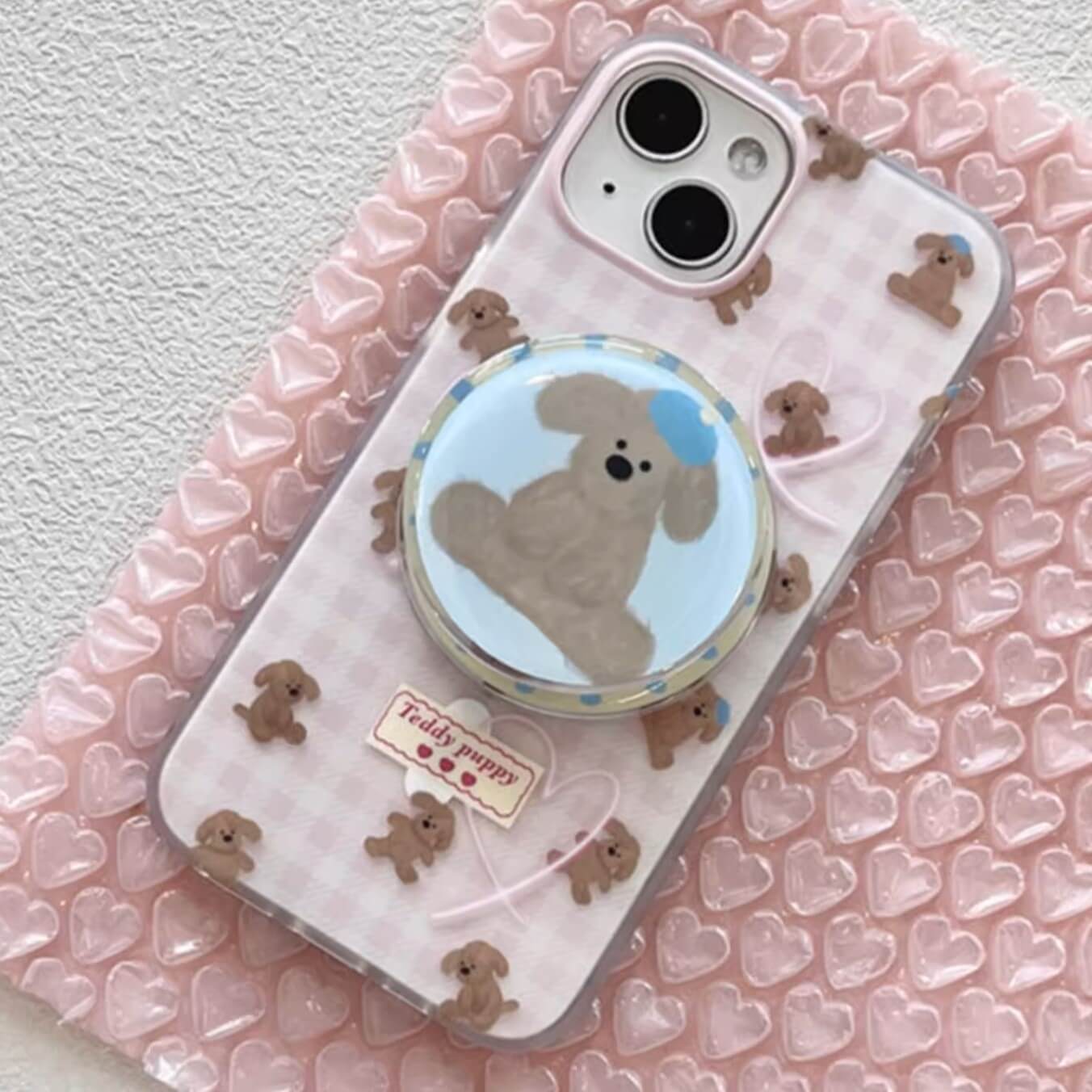 Sweet MagSafe-compatible case dotted with teddy bear puppies, ideal for adding whimsy to your tech