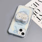 Charming MagSafe-compatible phone case displaying a heart with two cute puppies and 'sweet time' text, against a sky-blue background with soft clouds, next to a heart-shaped MagSafe popsocket with a matching design.